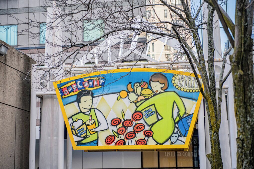 A colorful mural with cartoon characters and text on a building facade.