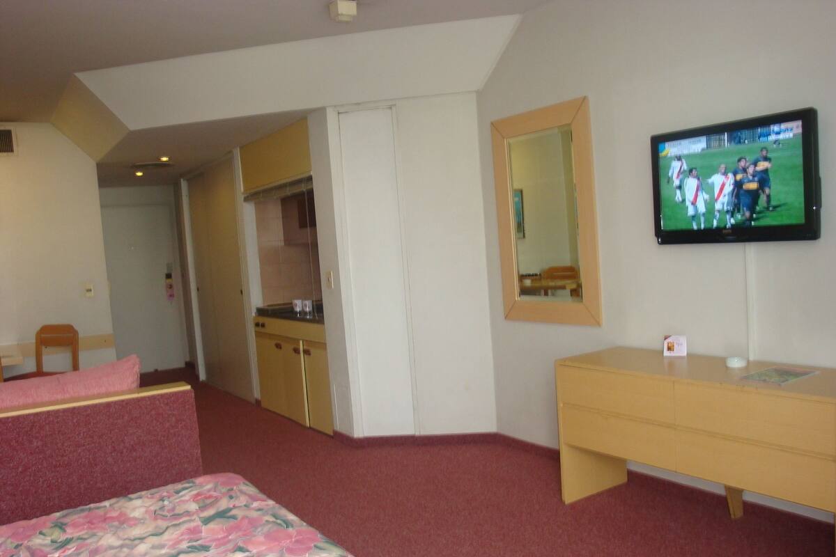 Executive Quadruple Room | Minibar, in-room safe, desk, blackout drapes