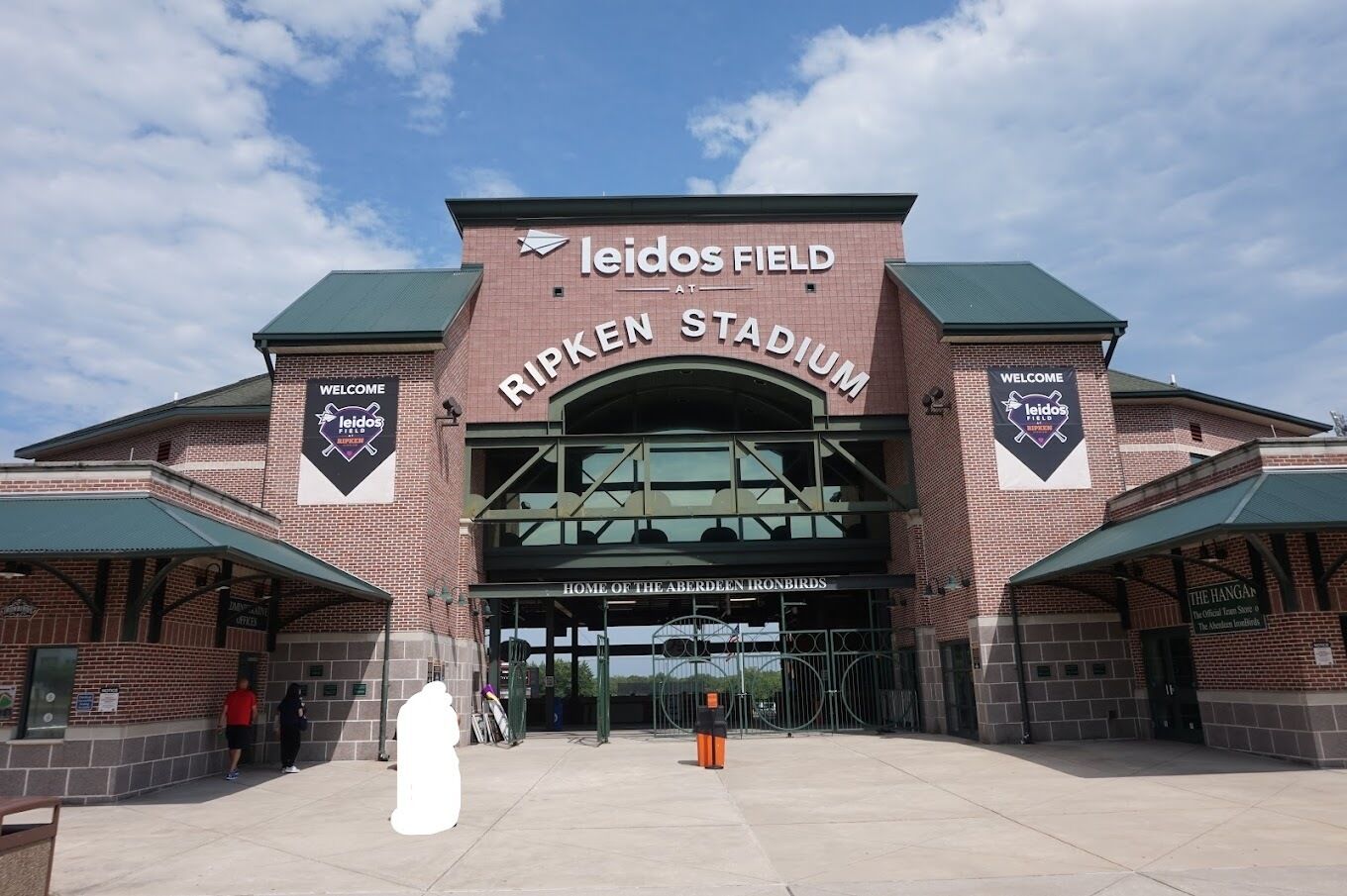 Ripken Stadium with a clear entrance, a large sign reading "Leidos Field at Ripken Stadium", and banners for "Leidos Field" and "Welcome".