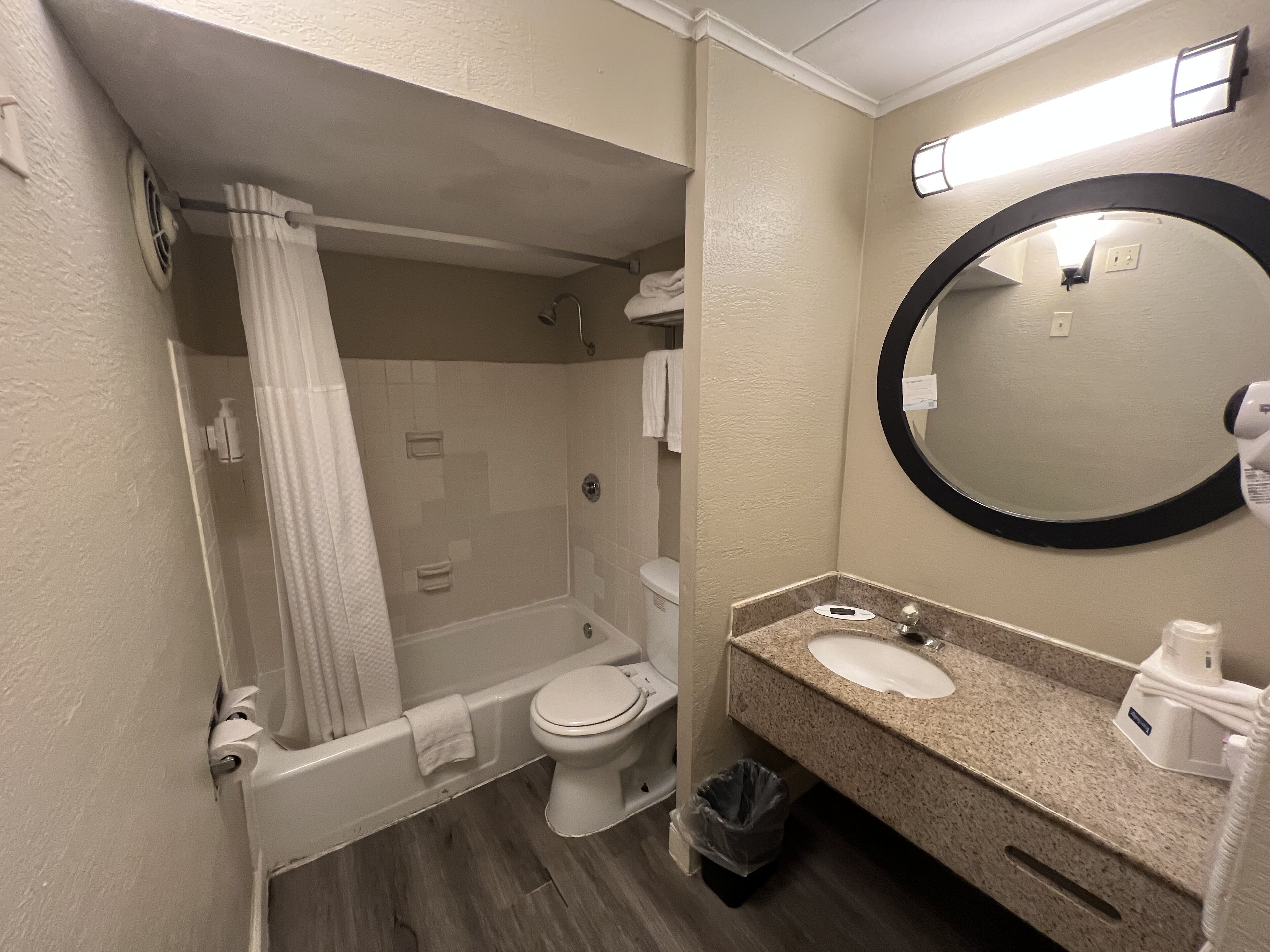 A bathroom with a bathtub, toilet, and sink.