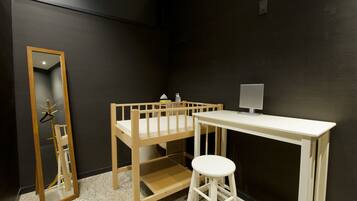 Cozy retreat with a bunk bed, desk, and mirror.