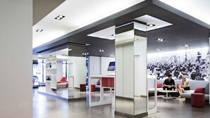 A modern interior with a reception area, seating, and a large wall mural. - Novotel Montreal Centre (Montreal)