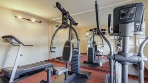 A gym with treadmills, weight machines, and a stationary bike. - Hutchi Bell (Hutchinson)