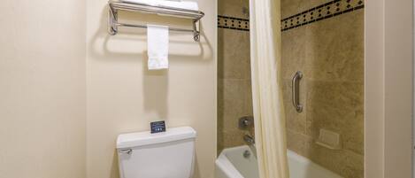 A bathroom with a toilet, a shower, and a bathtub.