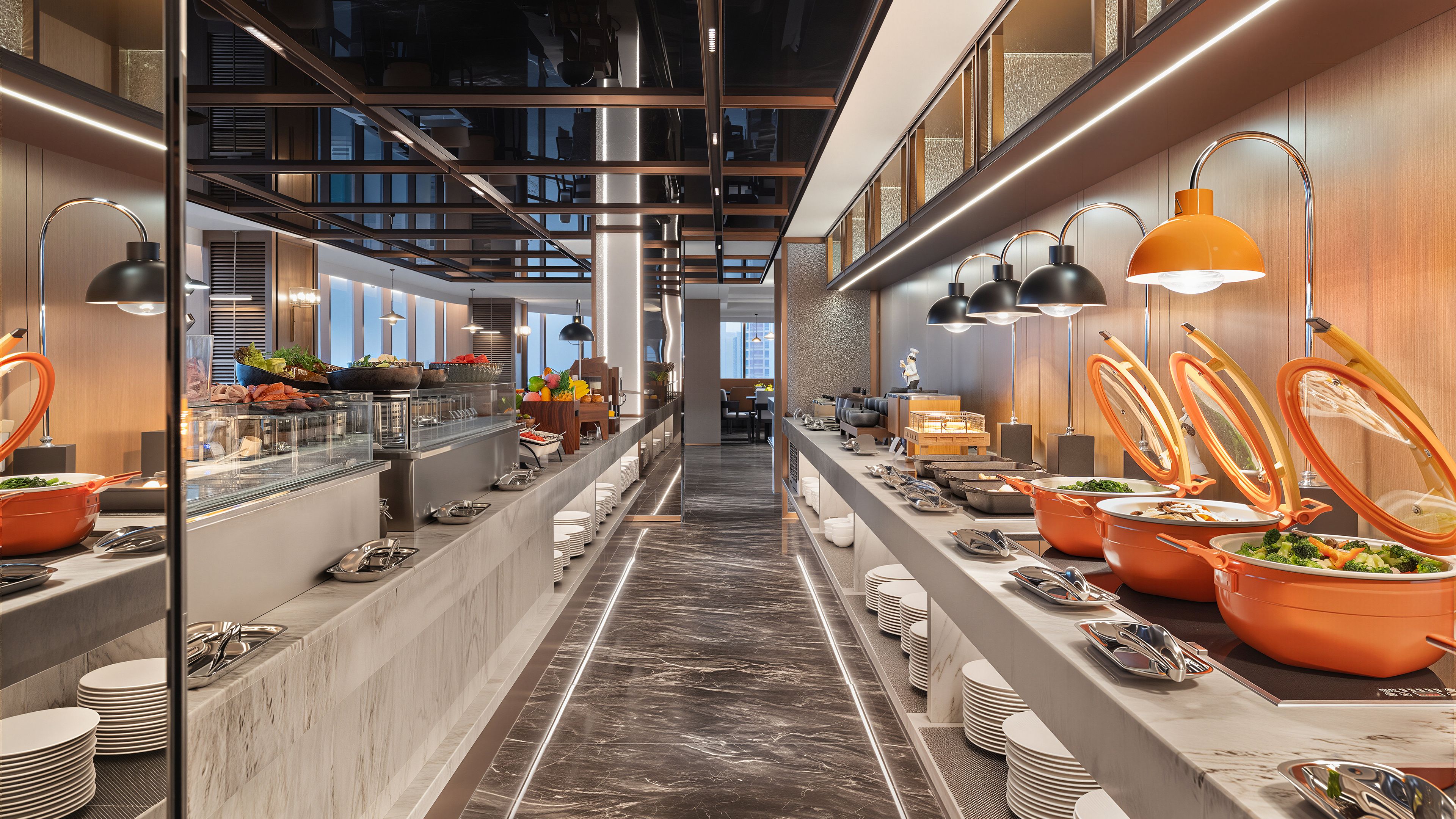 A modern buffet setup with multiple serving stations, a central walkway, and overhead lighting.