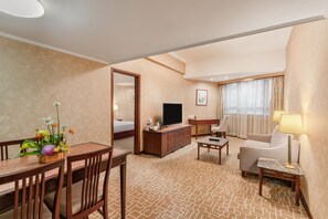 Deluxe Suite | Living area | 28-inch LCD TV with satellite channels, TV