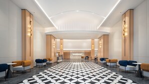 A modern hotel lobby with a geometric patterned floor, seating areas, and a reception desk. - Holiday Inn Express Shenzhen Luohu Port by IHG (Shenzhen)