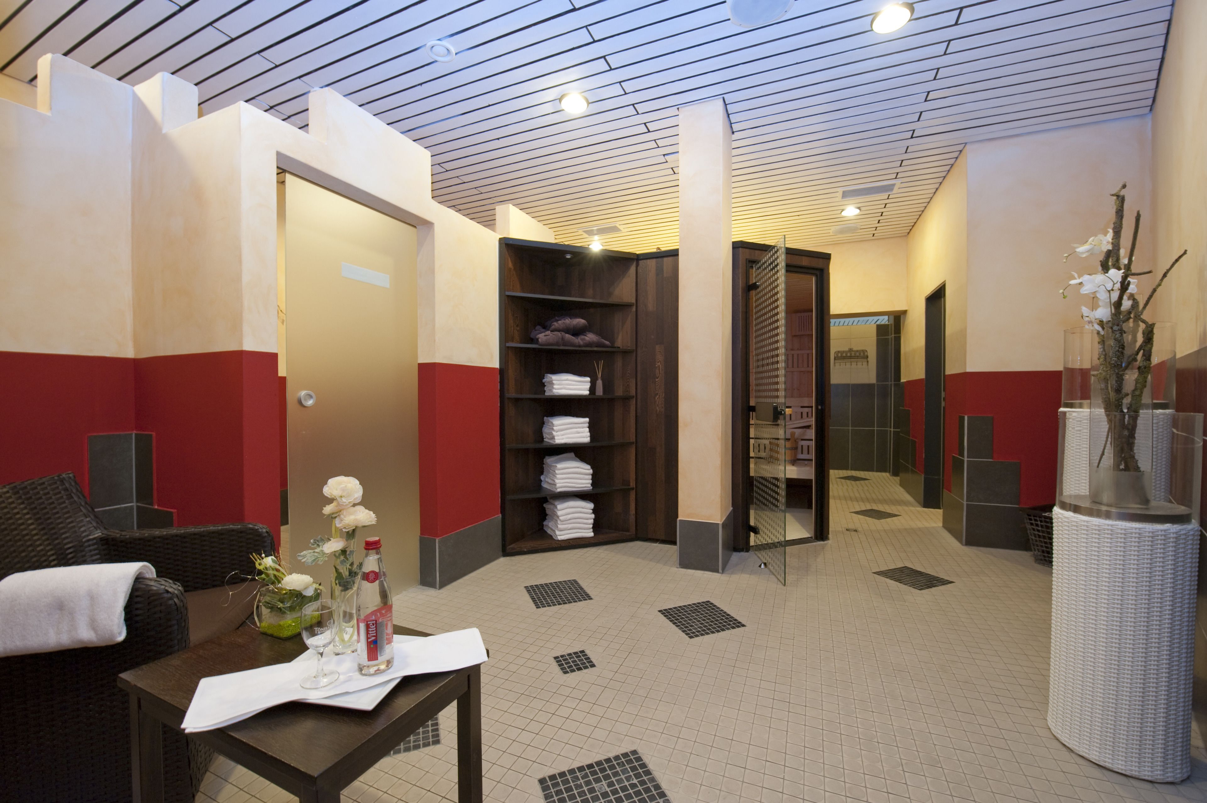 A hotel lobby with a reception desk, seating area, and a reception counter.