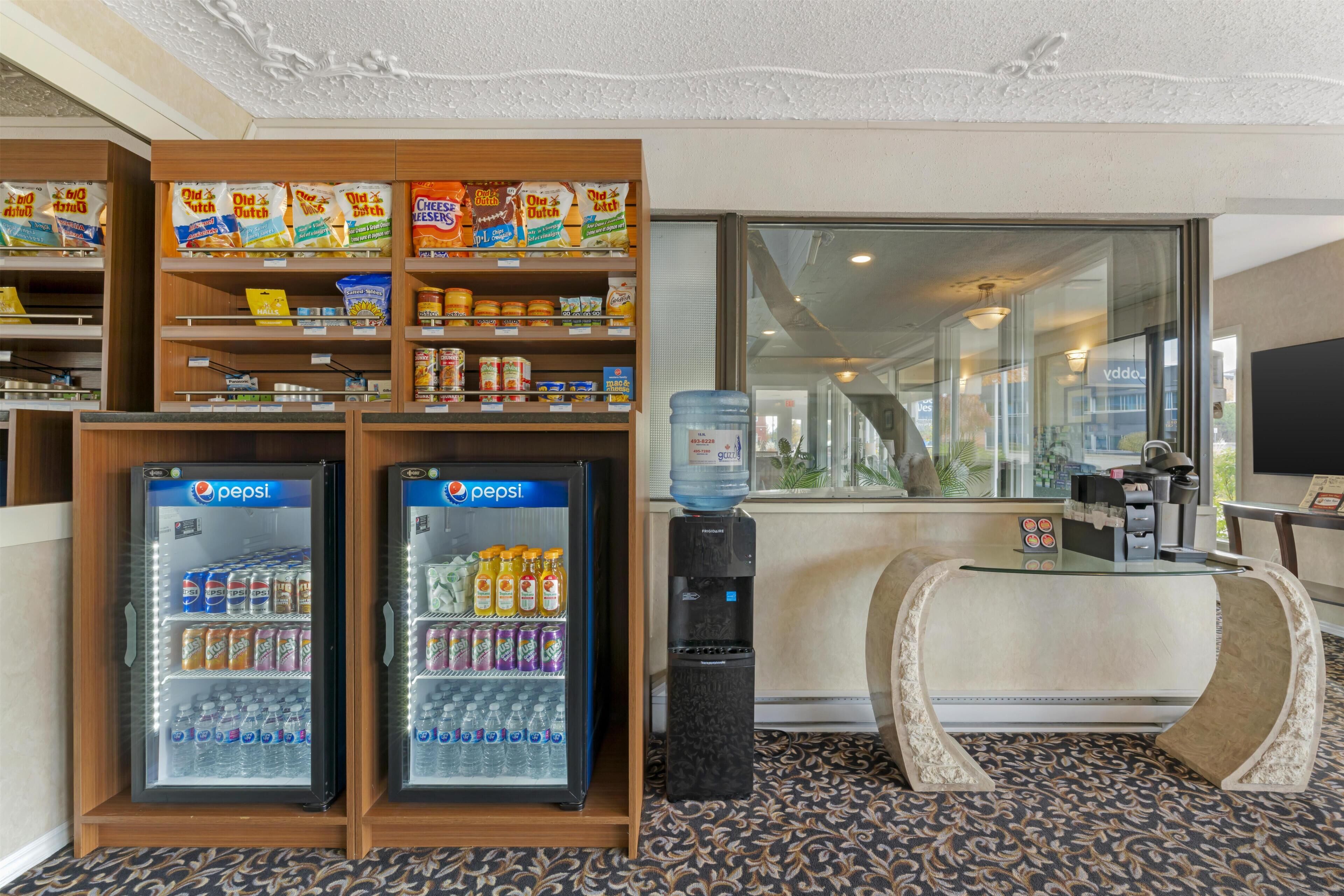 A hotel lobby with vending machines, a water dispenser, and a reception desk.