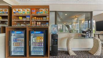 A hotel lobby with vending machines, a water dispenser, and a reception desk.