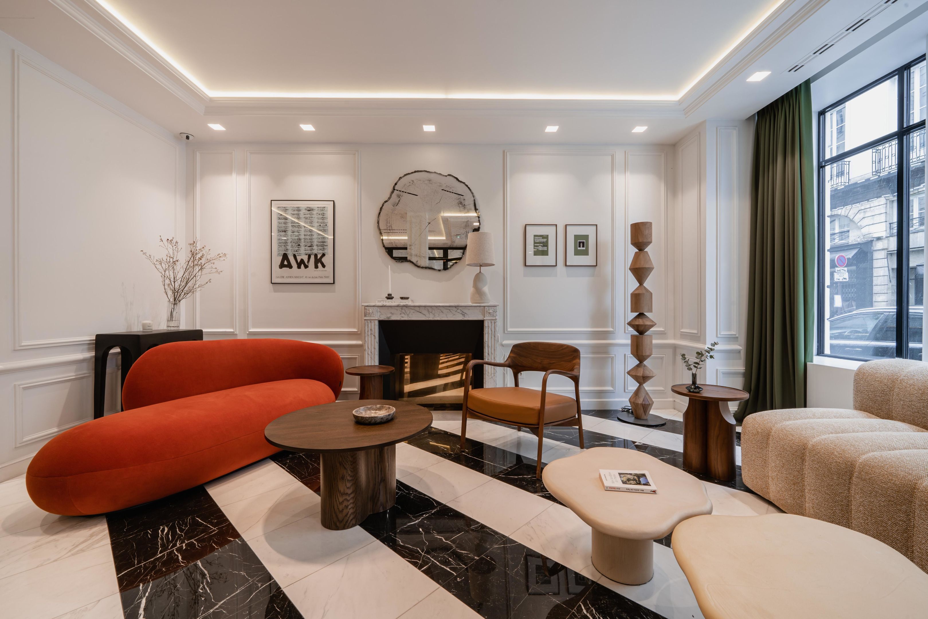 A modern living room with a fireplace, a sofa, a coffee table, and a side table.
