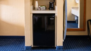 A compact kitchenette with a microwave, coffee maker, and a small refrigerator.