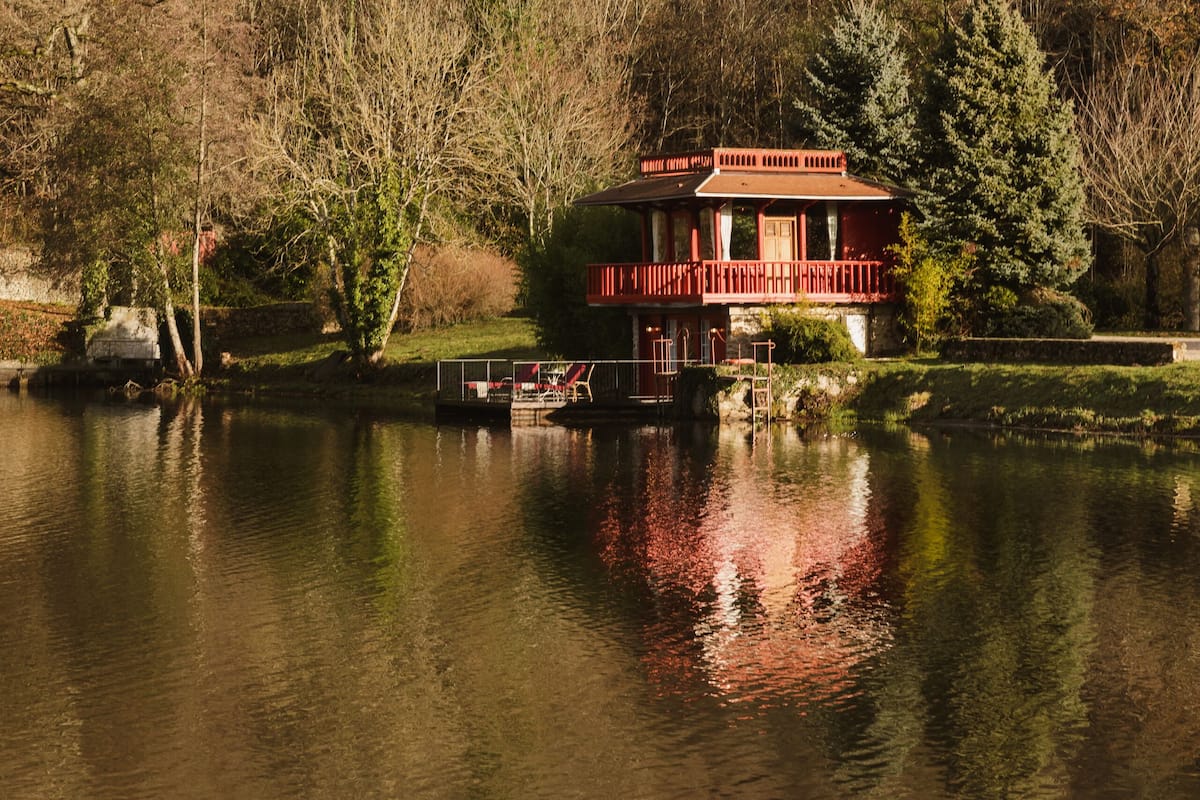 Situated on the lake's edge, this serene retreat offers a tranquil view of the surrounding greenery and the calm water.