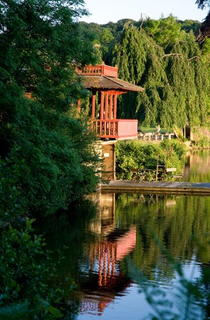Situated by the river, this serene pavilion offers a peaceful vantage point over lush greenery.