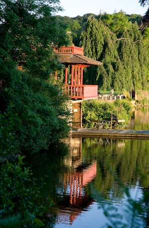 Situated by the river, this serene pavilion offers a peaceful vantage point over lush greenery.