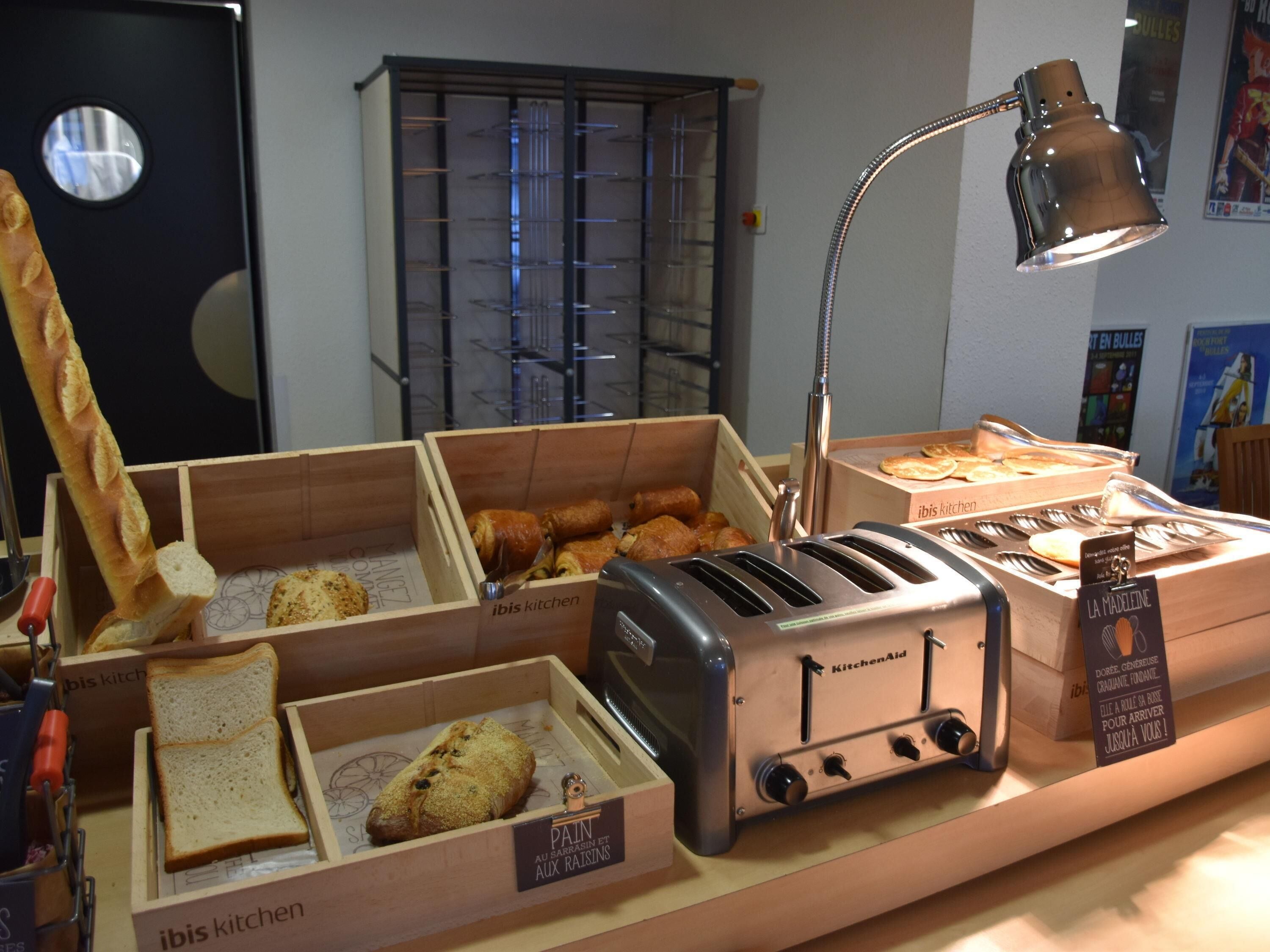A bakery display with bread, pastries, and a toaster.