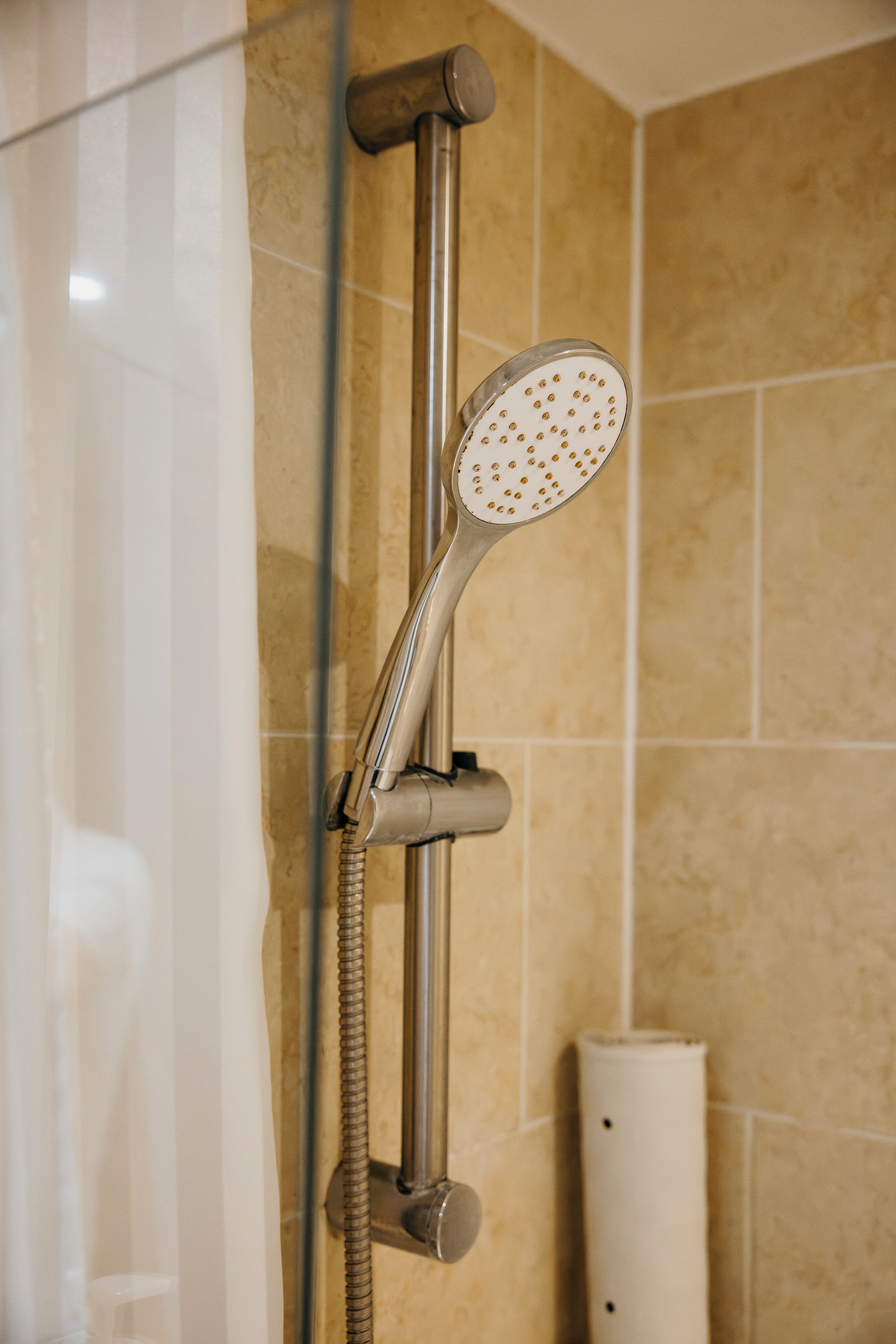 A shower with a handheld showerhead and a flexible hose.