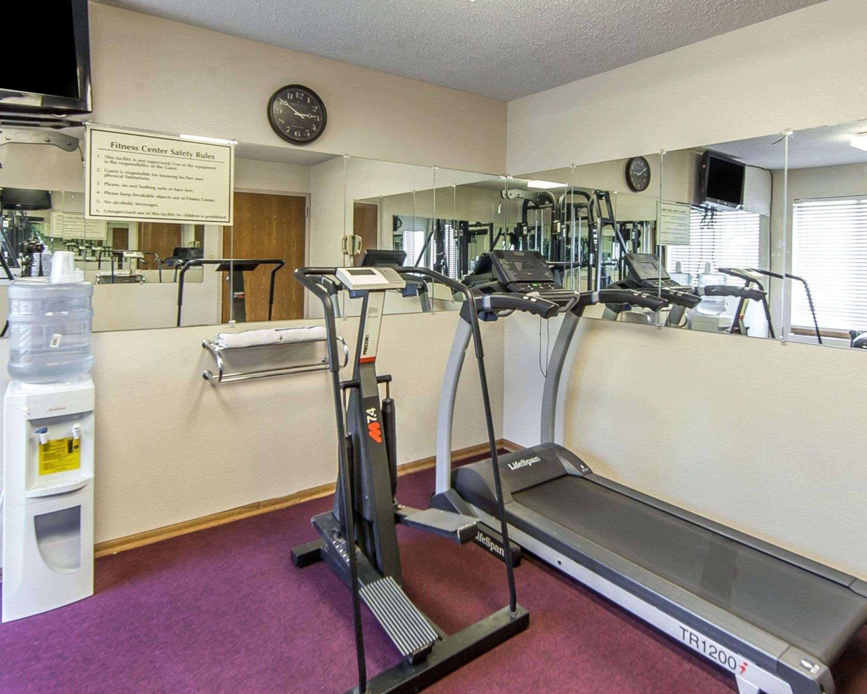 A fitness center with treadmills, a water dispenser, and exercise equipment.