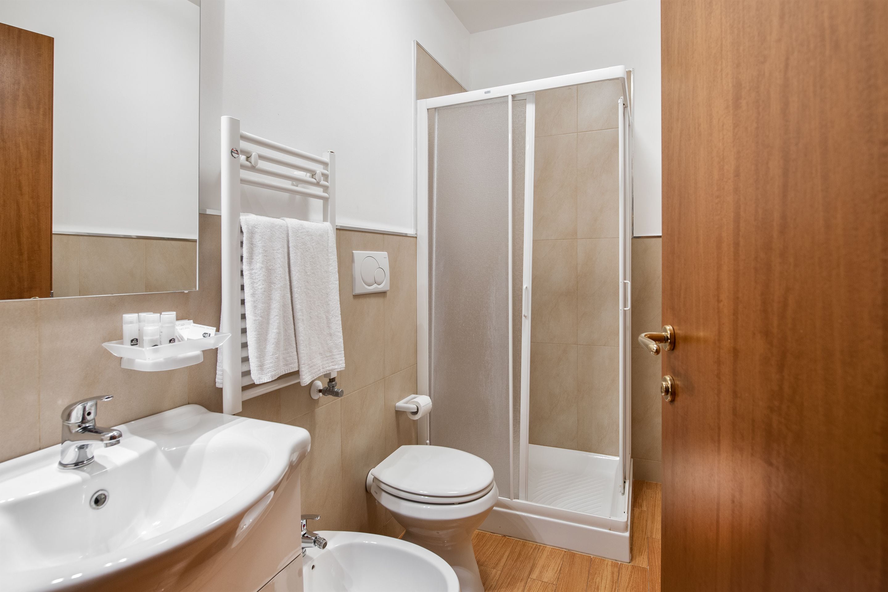 A bathroom with a sink, toilet, and shower.