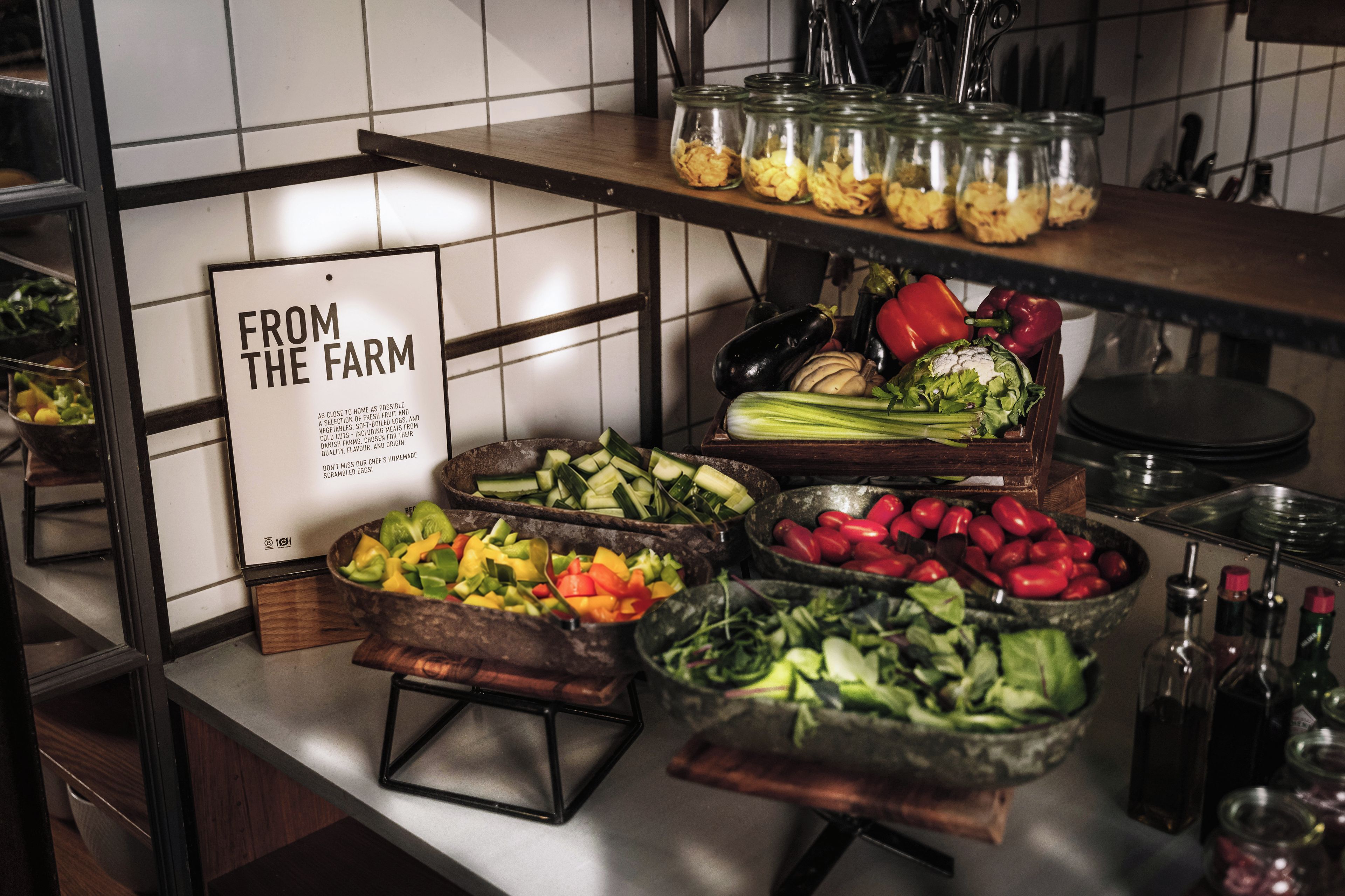 A kitchen counter with various food items and a sign that reads 'FROM THE FARM'.