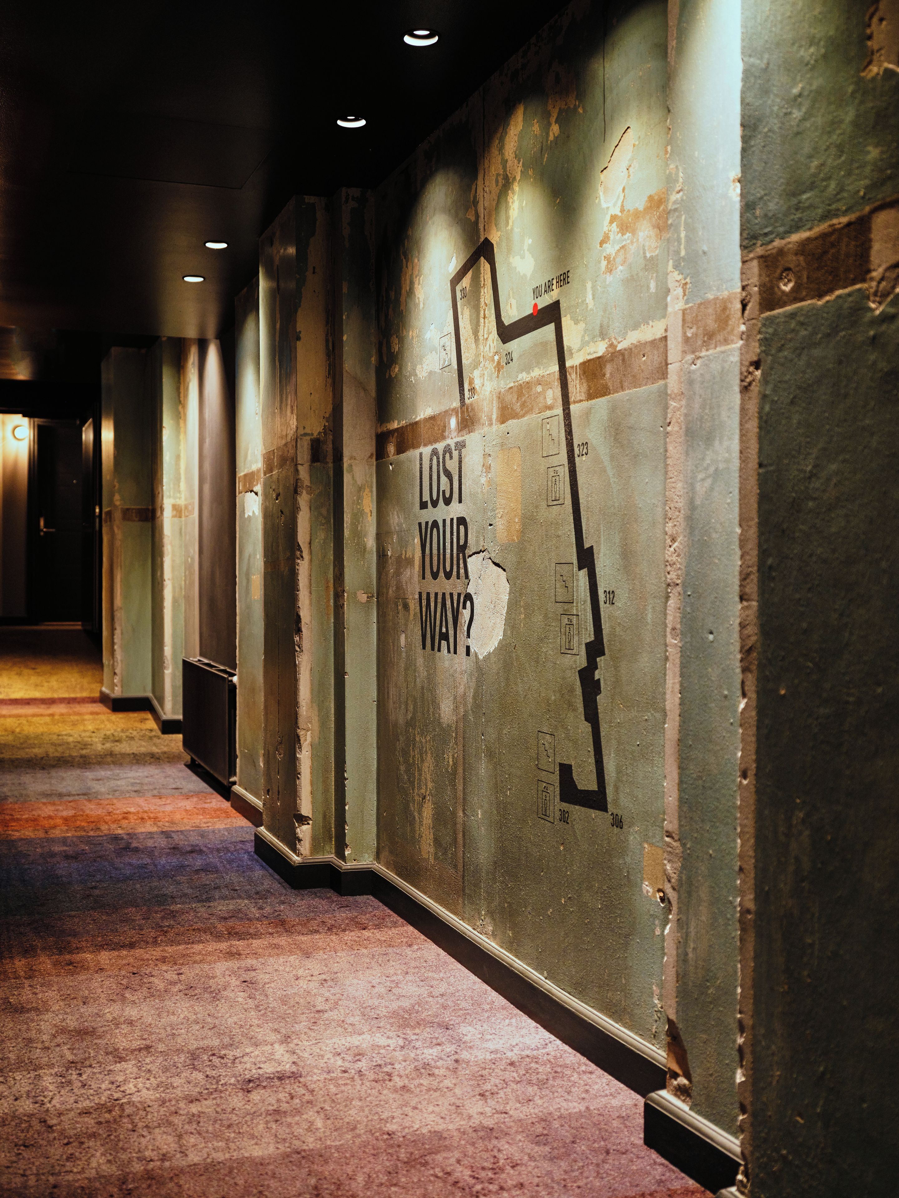 A corridor with a wall displaying a lost-and-found sign.