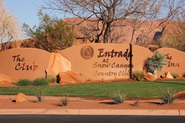 A sign for 'The Club' and 'The Inn' at Snow Canyon Country Club.
