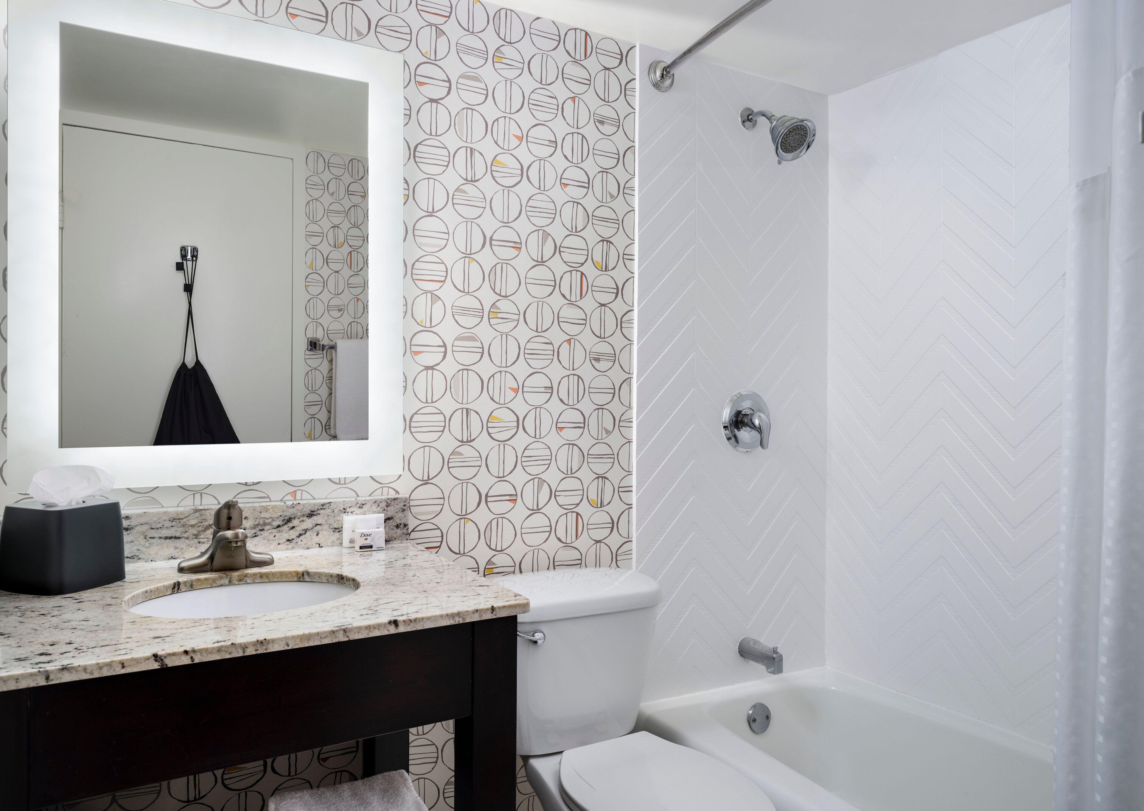 A bathroom with a marble sink, a toilet, a bathtub, and a shower.