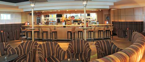 A bar area with striped seating and a bar counter.