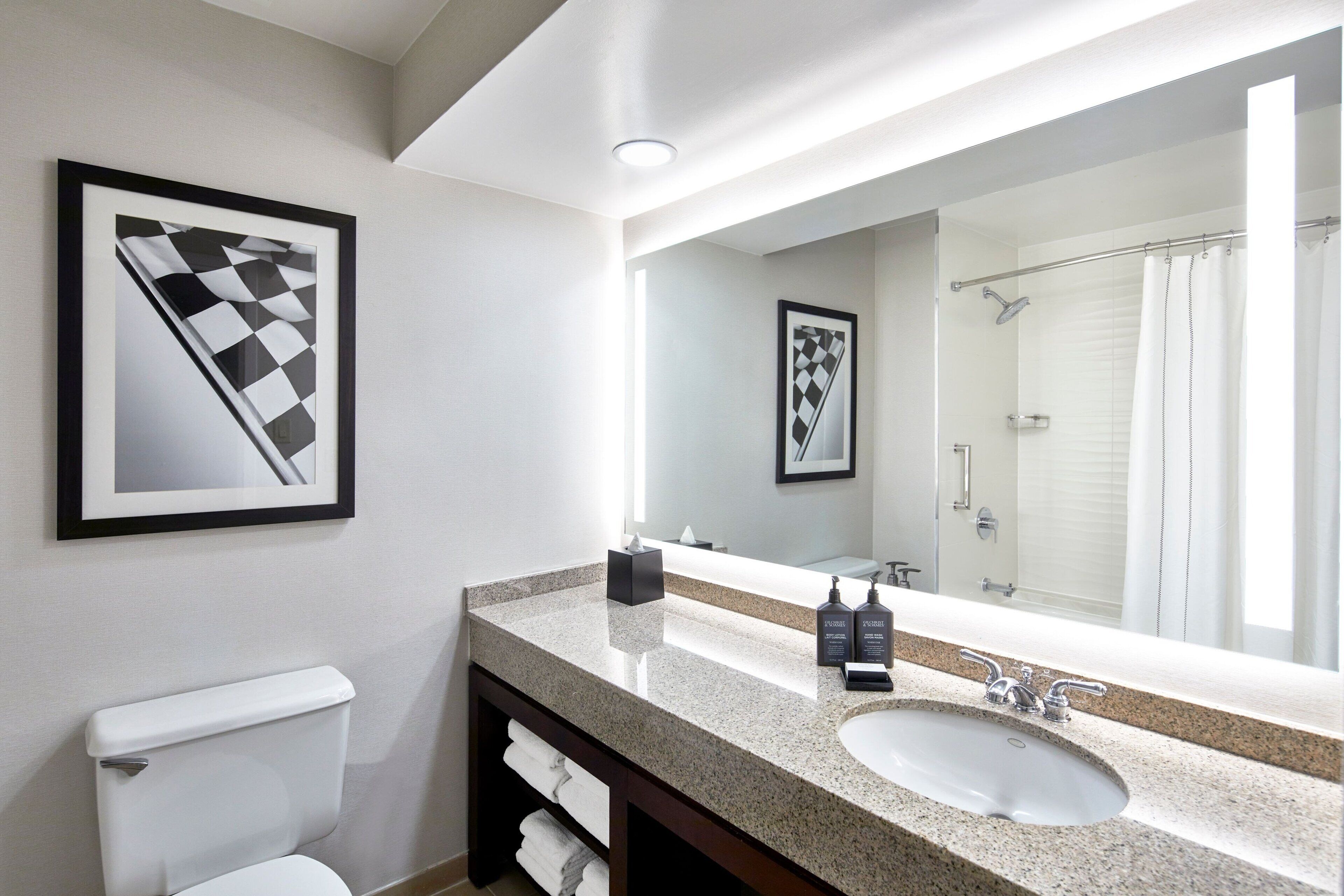 combined shower/bathtub, designer toiletries, hair dryer, towels