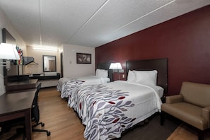 A hotel room with two beds, a desk, a chair, and a TV. - Red Roof Inn Champaign - University (Champaign)