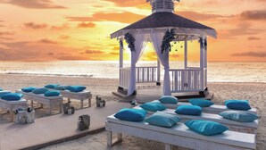A beach gazebo with white railings and a roof, surrounded by lounge chairs with blue cushions. - The Westin Grand Cayman Seven Mile Beach Resort & Spa (Seven Mile Beach)
