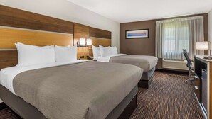 A hotel room with two beds, a desk with a chair, a window with curtains, and a painting on the wall. - Quality Inn Asheboro South (Asheboro)