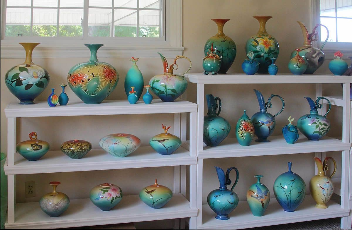 A display of various ceramic vases on shelves.