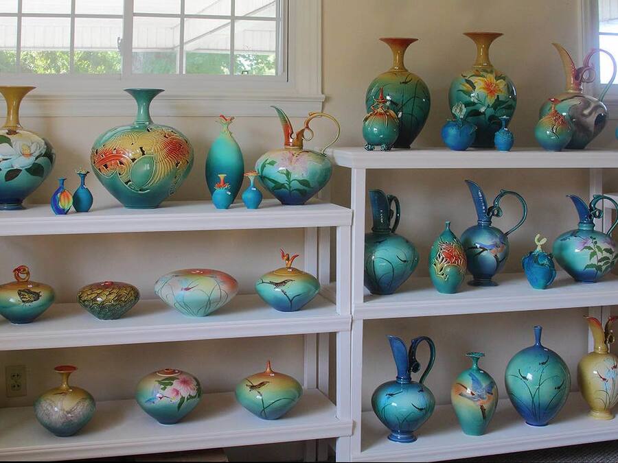 A display of various ceramic vases on shelves.