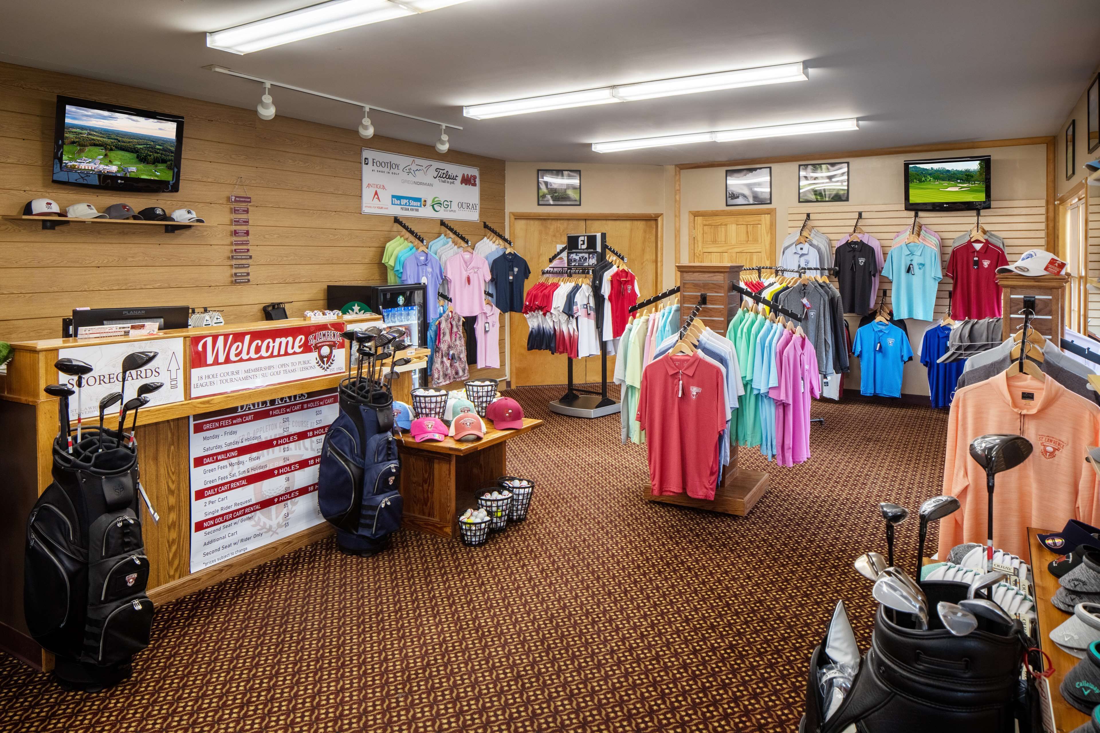 A golf shop with racks of golf apparel, golf bags, and accessories.