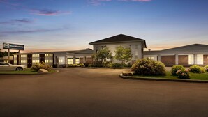 A Best Western hotel with a large parking lot, multiple buildings, and well-maintained landscaping.