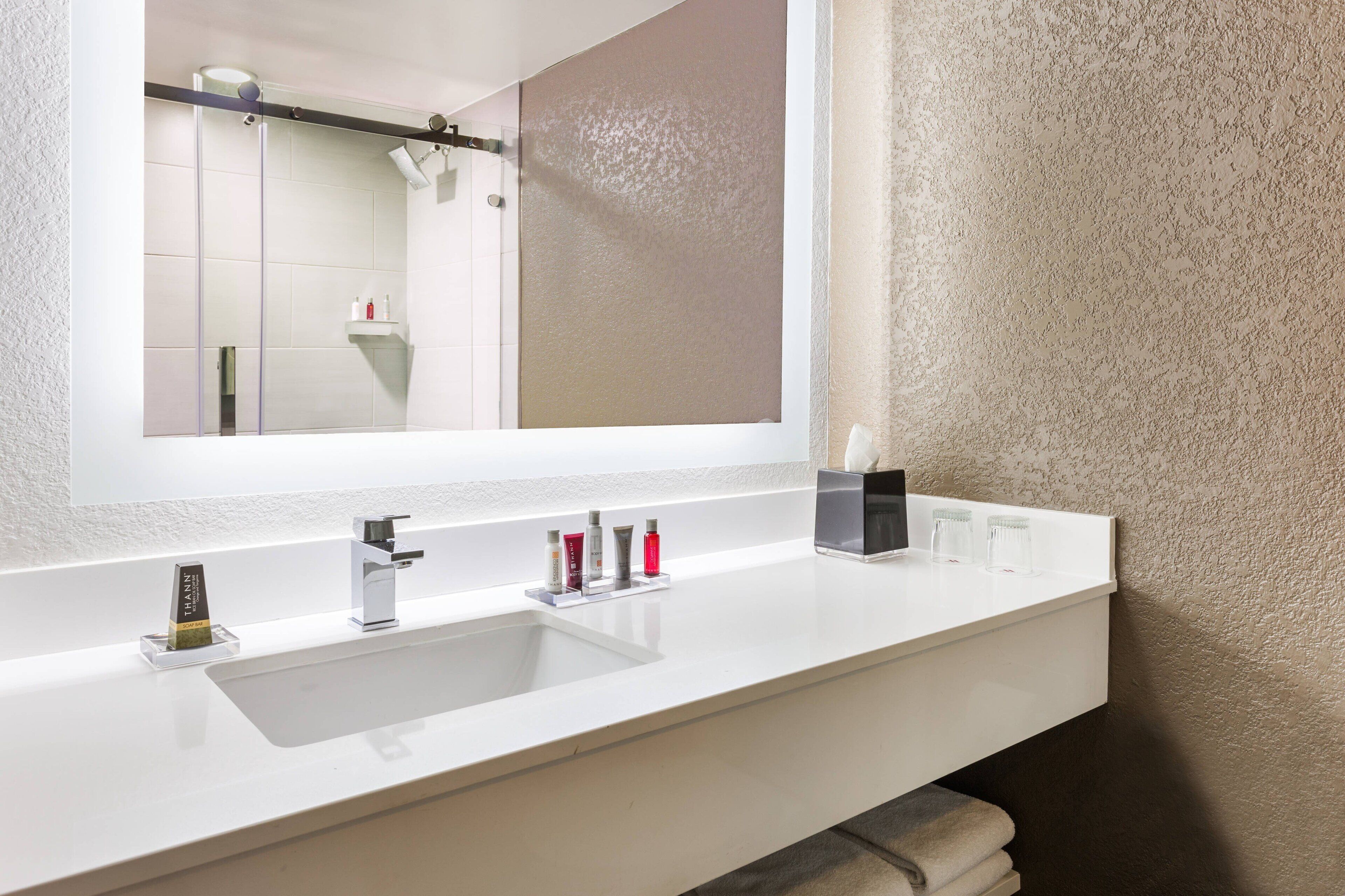 shower, designer toiletries, hair dryer, towels