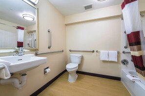 A bathroom with a sink, toilet, and shower area. - Red Roof Inn Seattle Airport - SEATAC (SeaTac)