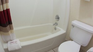 A bathroom with a bathtub, toilet, and a towel rack. - Red Roof Inn Seattle Airport - SEATAC (SeaTac)