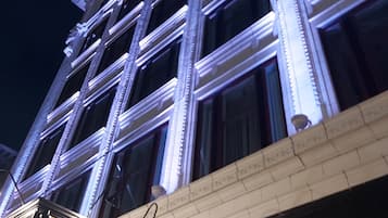 The exterior of the Strathcona Hotel with illuminated windows and a signboard.