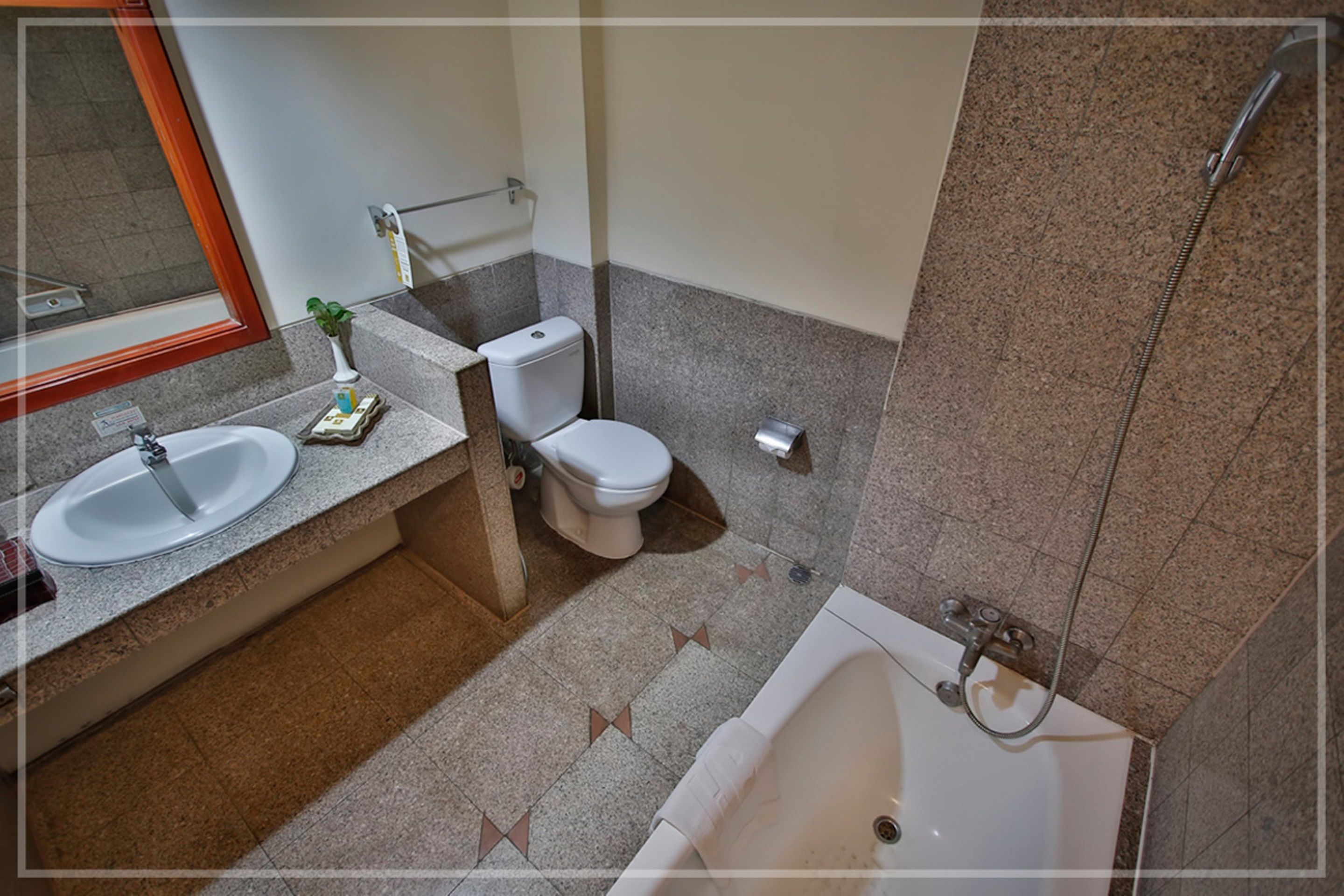 A bathroom with a sink, toilet, and bathtub.