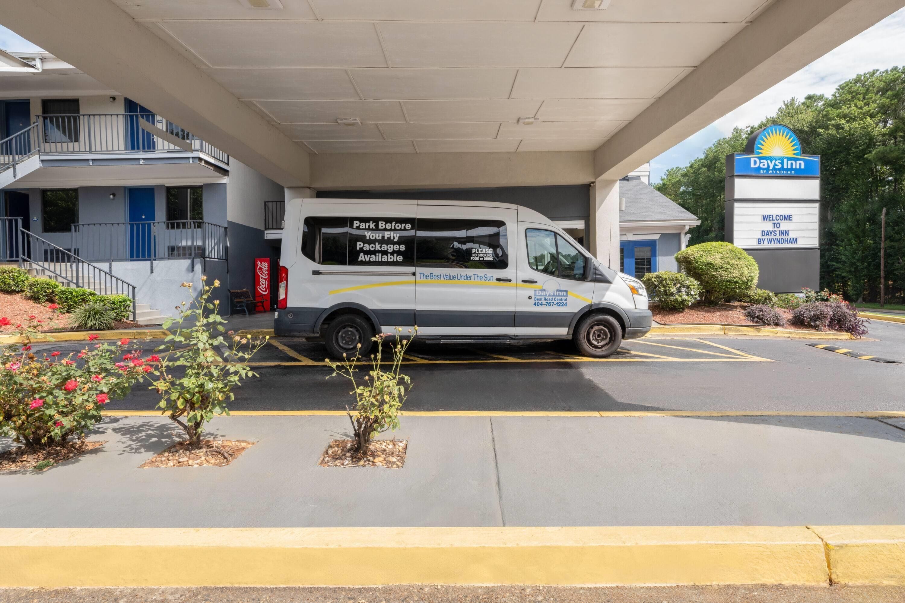 En parkeringsplads ved et Days Inn hotel, med en varevogn parkeret under bygningen.