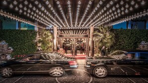 A grand entrance with a canopy of lights, a red carpet, and two luxury cars parked in front. - Rome Cavalieri, A Waldorf Astoria Hotel (Rome)