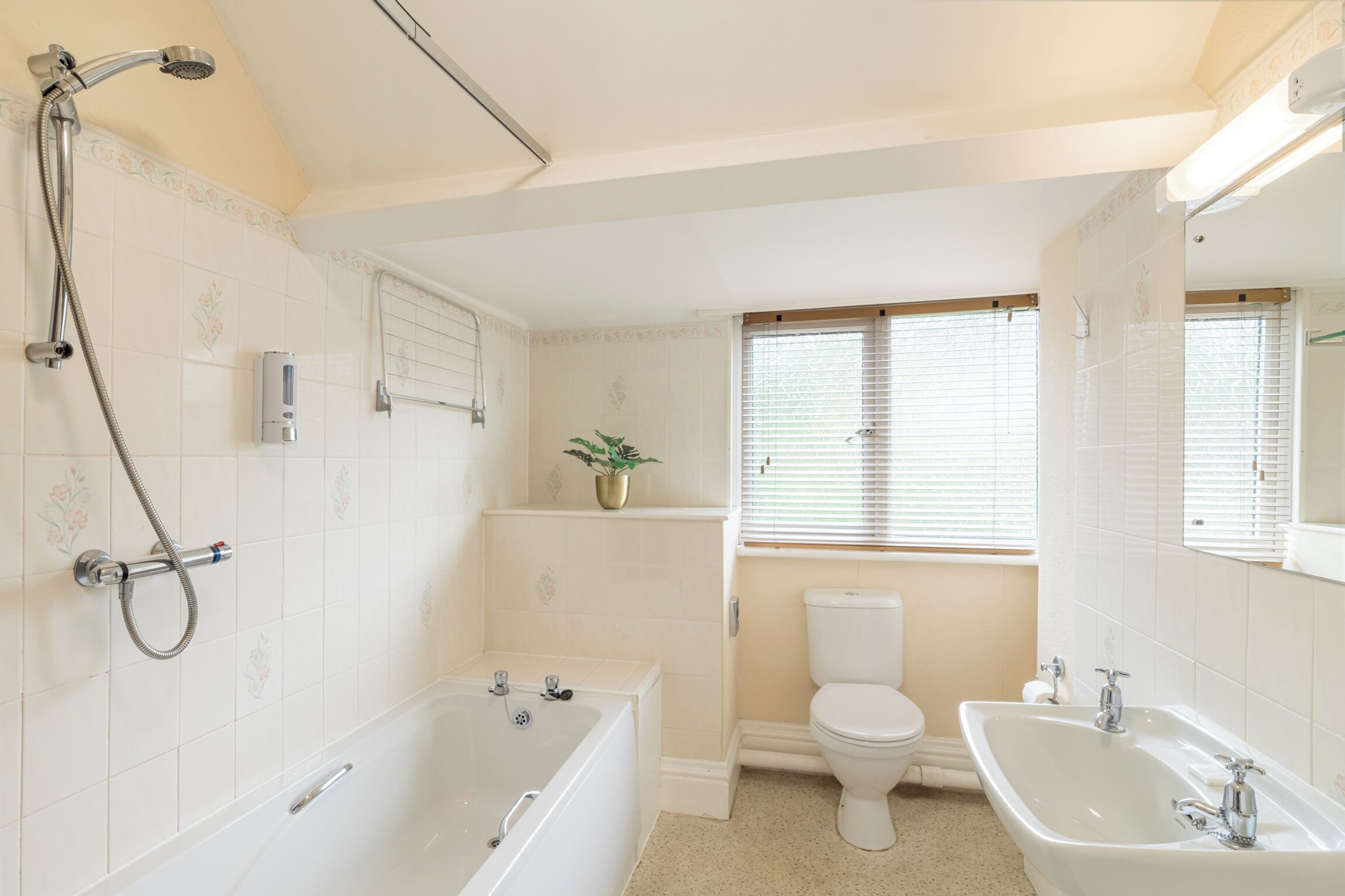 A bathroom with a bathtub, a sink, and a toilet.