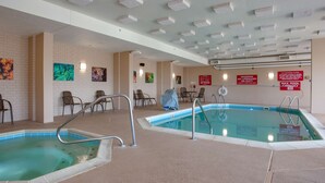 An indoor swimming pool with multiple lanes, safety signs, and a tiled floor. - Drury Inn & Suites Terre Haute (Terre Haute)