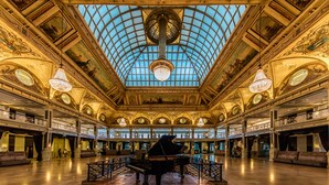 A grand hall with a large piano, ornate ceiling, and multiple balconies. - Grand Hotel Amrâth Kurhaus The Hague Scheveningen (The Hague)