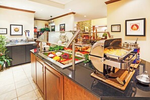 A buffet area with various food items and a beverage station. - Staybridge Suites Oak Ridge by IHG (Oak Ridge)