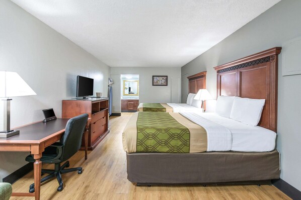 Relax in a spacious room with a large bed, desk, and mounted TV.