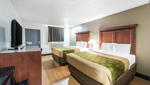 A hotel room with two beds, a desk with a television, and a window with curtains. - Rodeway Inn St. Joseph (Saint Joseph)