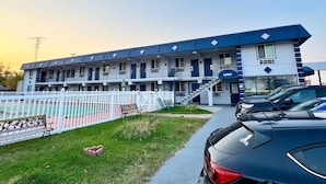 A multi-story motel with a blue and white exterior, a visible 'Lobby' sign, and a parking area with cars. - Rodeway Inn St. Joseph (Saint Joseph)